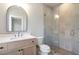 Bathroom featuring a modern vanity, a curved mirror, and a glass shower at 145 Cedarwood Ln, Roswell, GA 30075