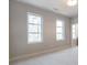 Bright bedroom boasts large windows offering ample natural light and serene views at 145 Cedarwood Ln, Roswell, GA 30075