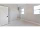 Bright bedroom with white trim, neutral walls, carpet, and natural light from energy-efficient windows at 145 Cedarwood Ln, Roswell, GA 30075