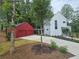 Charming modern home with a red garage and a well-manicured lawn at 145 Cedarwood Ln, Roswell, GA 30075
