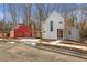 Modern farmhouse with red garage, walkway, and a combination of siding types at 145 Cedarwood Ln, Roswell, GA 30075