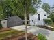 View of a modern home's exterior with a detached two-car garage at 145 Cedarwood Ln, Roswell, GA 30075