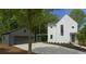 Modern home featuring a white exterior, gray garage, and a concrete driveway at 145 Cedarwood Ln, Roswell, GA 30075