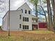 Back exterior showcasing the deck, gray siding and black framed windows of this modern two story home at 145 Cedarwood Ln, Roswell, GA 30075