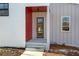 Inviting front entrance with a modern door, gray siding, and red accents at 145 Cedarwood Ln, Roswell, GA 30075