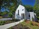 Charming two-story home with a concrete walkway leading to the front door and well-manicured landscaping at 145 Cedarwood Ln, Roswell, GA 30075