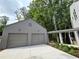 Two car garage with a covered walkway to the main house at 145 Cedarwood Ln, Roswell, GA 30075