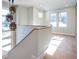 Upstairs landing featuring hardwood floors, modern light fixture and plenty of natural light at 145 Cedarwood Ln, Roswell, GA 30075