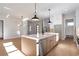 Spacious kitchen island with stainless steel appliances, pendant lighting, and hardwood floors at 145 Cedarwood Ln, Roswell, GA 30075