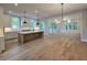 Open-concept kitchen featuring an island, hardwood floors, and natural light at 145 Cedarwood Ln, Roswell, GA 30075