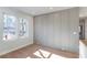 Sun-drenched living room featuring stylish wall paneling and gleaming hardwood floors at 145 Cedarwood Ln, Roswell, GA 30075