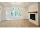Bright living room featuring a fireplace, mantle and large windows at 145 Cedarwood Ln, Roswell, GA 30075
