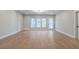 Spacious living room with hardwood flooring, natural light, and an entry door to the backyard at 145 Cedarwood Ln, Roswell, GA 30075