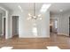 Bright, neutral living room with hardwood floors and modern chandelier at 145 Cedarwood Ln, Roswell, GA 30075