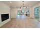 Open-concept living room with a fireplace and views into the kitchen and staircase at 145 Cedarwood Ln, Roswell, GA 30075