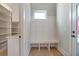 Stylish mudroom featuring a built-in bench, shelving, and convenient access to the outside at 145 Cedarwood Ln, Roswell, GA 30075