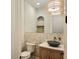 Unique powder room featuring stone wall detail and decorative lighting at 145 Cedarwood Ln, Roswell, GA 30075