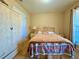 Bedroom with a cozy bed, carpet, and a decorative accent wall at 25 Horseshoe Ct, Covington, GA 30014