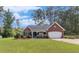 Charming single-story brick home with an attached garage, well-manicured lawn, and front garden at 25 Horseshoe Ct, Covington, GA 30014