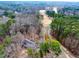 Aerial view of the house, large lot, golf course, and surrounding mature trees at 1980 Two Springs Way, Lawrenceville, GA 30043
