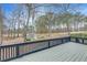 Wood deck overlooking the backyard, featuring a black railing and a shed in the background among tall trees at 1980 Two Springs Way, Lawrenceville, GA 30043