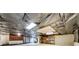 Unfinished basement featuring wrapped ceiling, concrete flooring, storage shelving, and utilities area at 1980 Two Springs Way, Lawrenceville, GA 30043