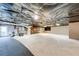 Unfinished basement with concrete floor and plastic-covered ceiling, offering potential for customization and added living space at 1980 Two Springs Way, Lawrenceville, GA 30043