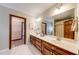 Bright bathroom features a double vanity, large mirror, tile floor and walk-in closet at 1980 Two Springs Way, Lawrenceville, GA 30043
