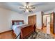 Bedroom with hardwood floors, ceiling fan, and neutral walls, creating a peaceful retreat at 1980 Two Springs Way, Lawrenceville, GA 30043