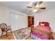 Bright bedroom with hardwood flooring, complemented by a ceiling fan for added comfort at 1980 Two Springs Way, Lawrenceville, GA 30043