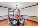 Formal dining room with hardwood floors, traditional chandelier, and views into the living room at 1980 Two Springs Way, Lawrenceville, GA 30043