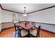 Formal dining room has chair rail, hardwood floors, a window, and traditional chandelier at 1980 Two Springs Way, Lawrenceville, GA 30043