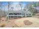 Charming home featuring a welcoming front porch and well-maintained landscaping in a wooded surrounding at 1980 Two Springs Way, Lawrenceville, GA 30043