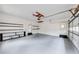 Spacious garage with ample storage shelves, and a clean, neutral painted floor at 1980 Two Springs Way, Lawrenceville, GA 30043