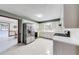Spacious kitchen featuring white cabinets, stainless steel appliances, tile backsplash, and white tile floor at 1980 Two Springs Way, Lawrenceville, GA 30043