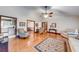 Bright living room boasts hardwood floors, neutral walls, ceiling fan, and access to the kitchen and dining room at 1980 Two Springs Way, Lawrenceville, GA 30043