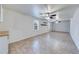 Bright living room with tiled floor, two windows, and ceiling fans, offering a comfortable space for relaxation and gatherings at 1980 Two Springs Way, Lawrenceville, GA 30043