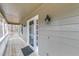 Close up of covered porch featuring glass door and outdoor lantern at 1980 Two Springs Way, Lawrenceville, GA 30043