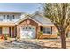 Charming brick home featuring a one-car garage and blossoming tree at 2139 Hickory Se Bnd # E, Conyers, GA 30013