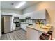 Modern kitchen with stainless steel appliances, granite countertops, and white cabinets at 2139 Hickory Se Bnd # E, Conyers, GA 30013