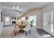 Spacious living area with large windows, fireplace, and elegant dining set at 2139 Hickory Se Bnd # E, Conyers, GA 30013