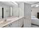 Well-lit bathroom featuring double sinks, modern fixtures, and ample counter space with easy access to the bedroom at 2964 Perimeter Cir, Buford, GA 30519