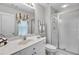 Updated bathroom featuring a modern vanity, a walk-in shower with glass doors, and stylish fixtures at 2964 Perimeter Cir, Buford, GA 30519