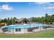 Community pool with lounge chairs, umbrellas, and lush greenery, perfect for relaxation and recreation at 2964 Perimeter Cir, Buford, GA 30519