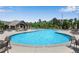 Large community pool with ample seating, umbrellas, and surrounding green space for residents to enjoy at 2964 Perimeter Cir, Buford, GA 30519