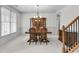 Formal dining room with neutral carpet, decorative chandelier, and elegant wood furniture set at 2964 Perimeter Cir, Buford, GA 30519