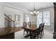 Elegant dining room featuring a large wood table, chandelier, and decorative wainscoting at 2964 Perimeter Cir, Buford, GA 30519