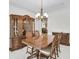 Formal dining area featuring a wooden table set with a china cabinet and chandelier lighting at 2964 Perimeter Cir, Buford, GA 30519