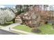 A well-manicured lawn and mature trees enhance the curb appeal of this charming two-story home at 2964 Perimeter Cir, Buford, GA 30519