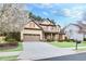 Charming two-story home with a well-manicured lawn, blossoming tree, and a two car garage at 2964 Perimeter Cir, Buford, GA 30519